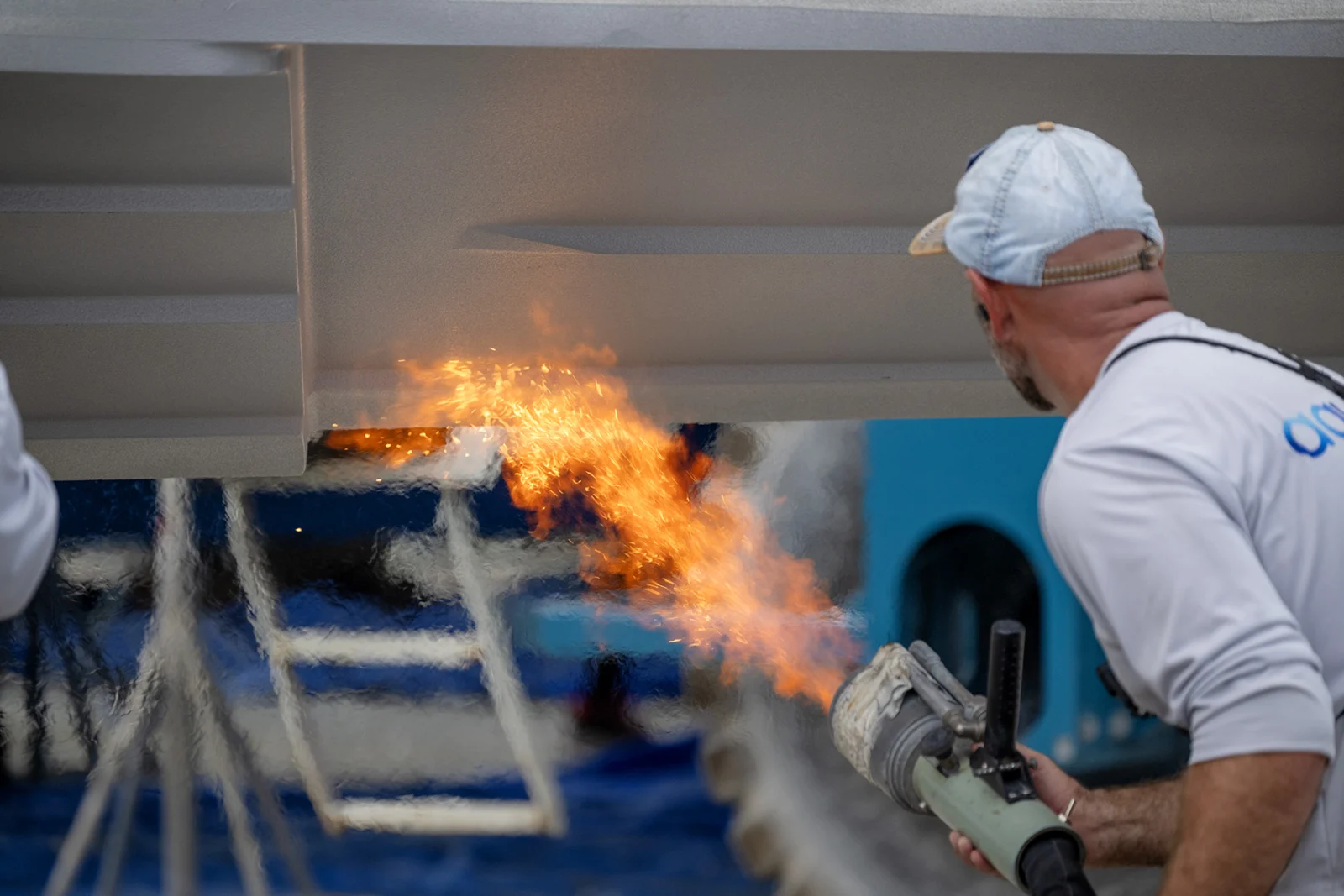 Close flame-spray application of Aquaphobix coating beneath a hull